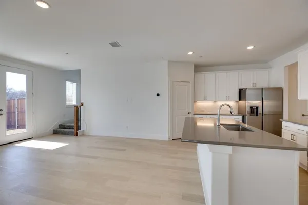 a kitchen with granite countertop a refrigerator and a sink