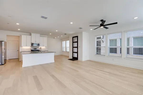 a view of kitchen with refrigerator and window