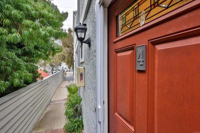 a view of a house with potted plants