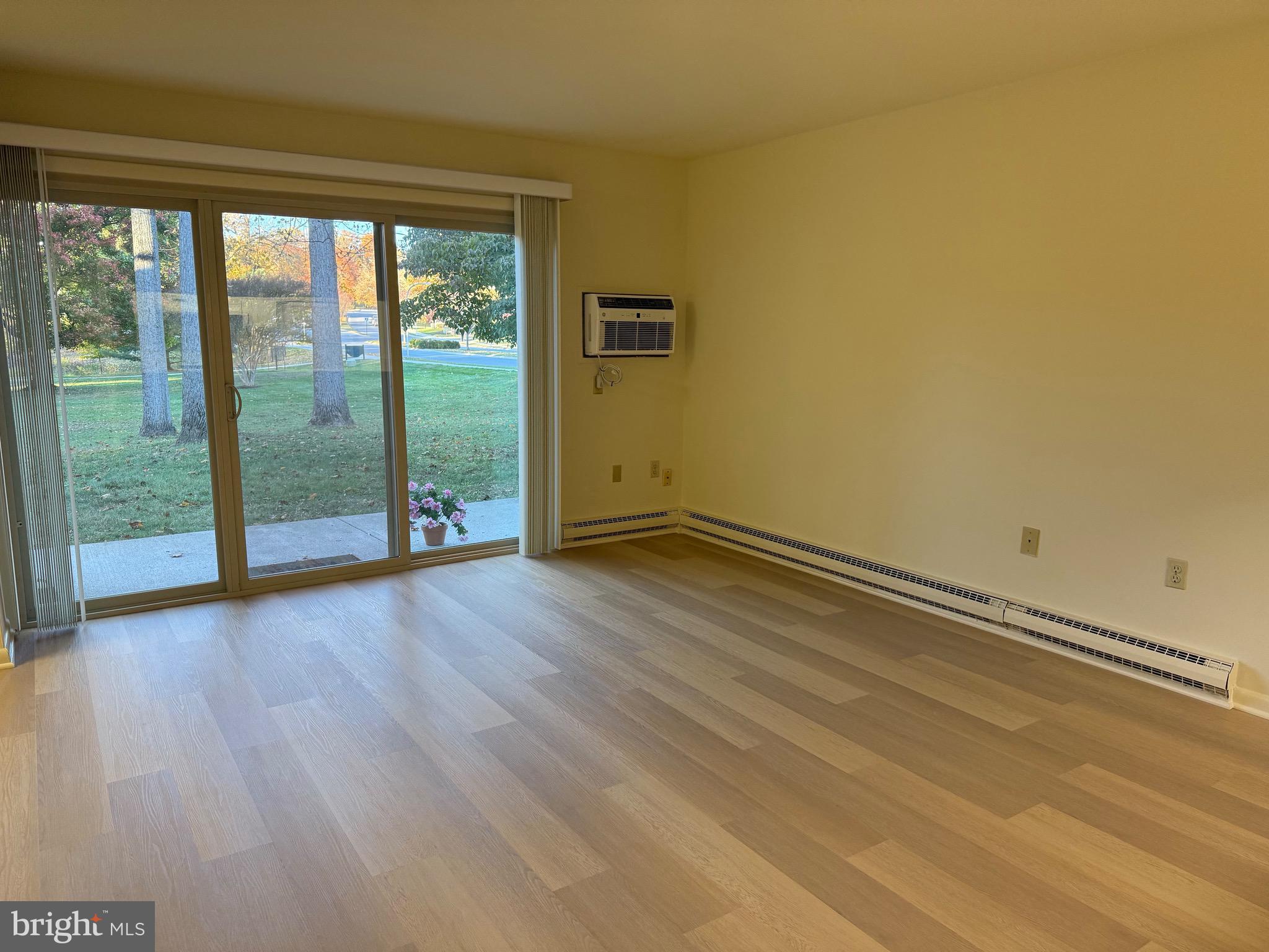 3301 South Leisure World Boulevard, Unit 991H Silver Spring, MD 20906 - Photo 11 of 25 a view of a room with wooden floor and window