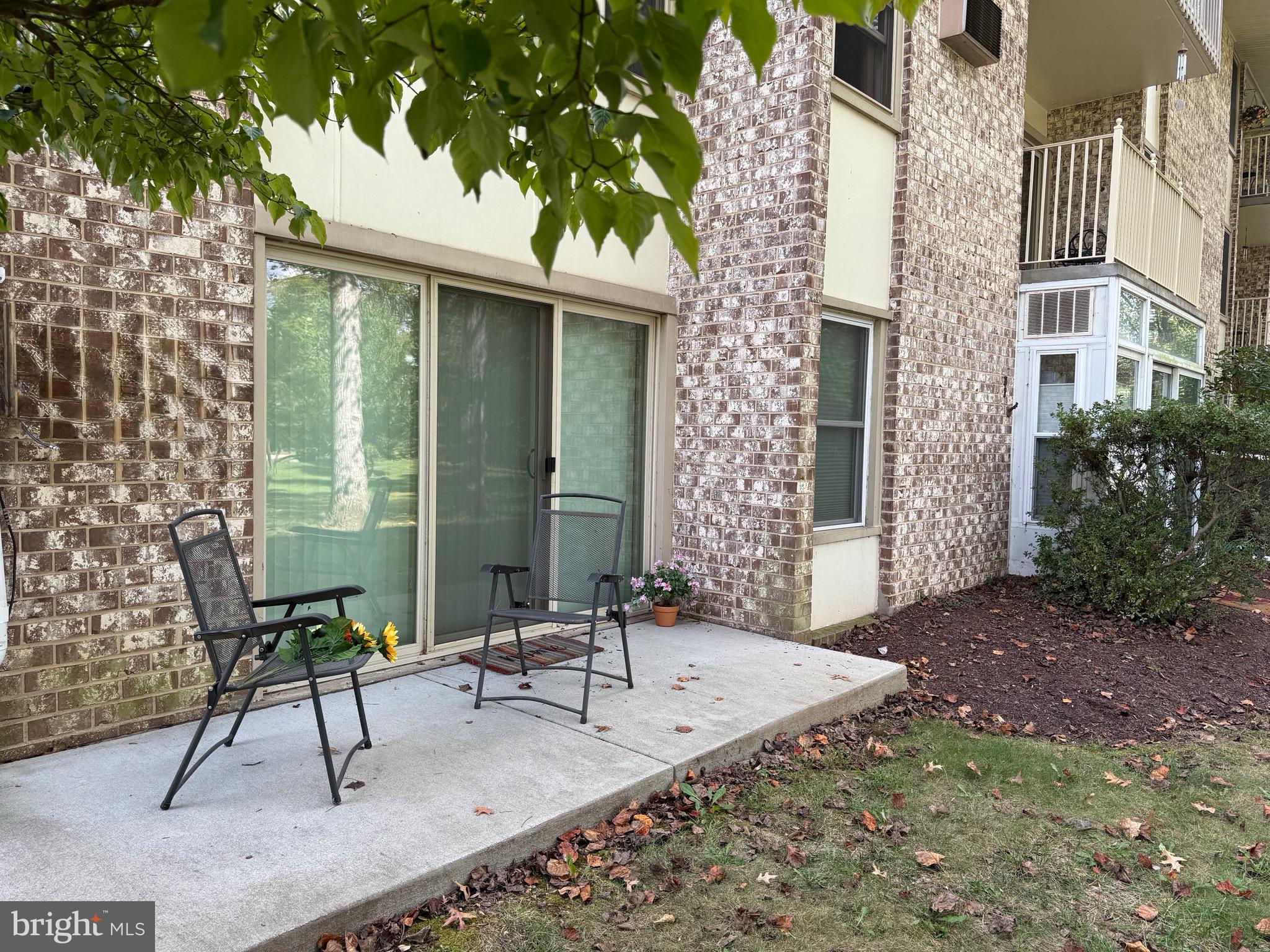 3301 South Leisure World Boulevard, Unit 991H Silver Spring, MD 20906 - Photo 10 of 25 a view of house with backyard and outdoor seating