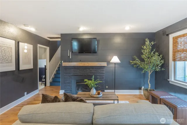 a living room with furniture and a potted plant