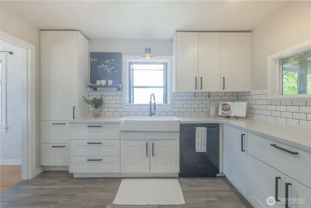 a kitchen with a sink stove and cabinets