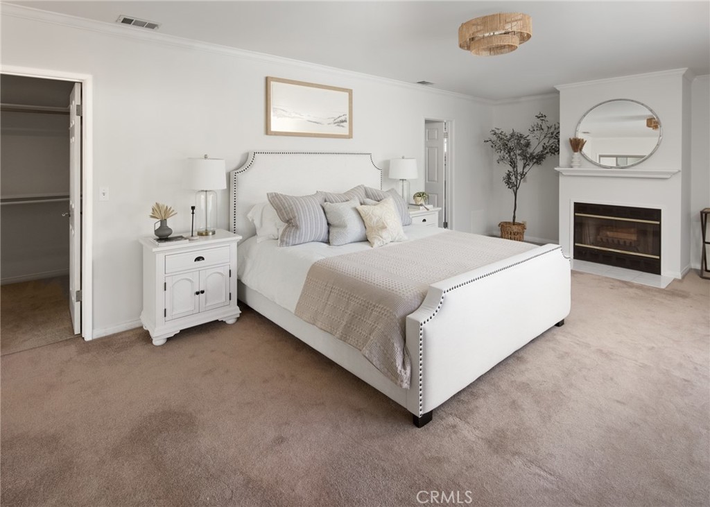 1261 East Maple Avenue El Segundo, CA 90245 - Photo 11 of 26 a spacious bedroom with a bed and a fireplace