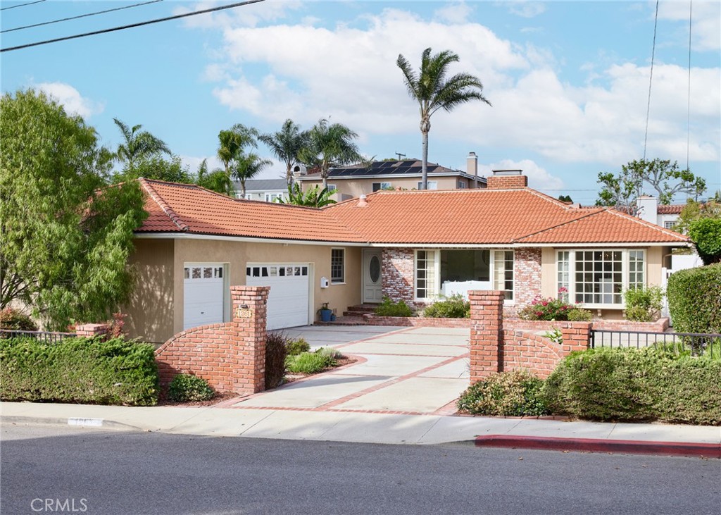 1261 East Maple Avenue El Segundo, CA 90245 - Photo 26 of 26 a front view of a house with a yard and potted plants
