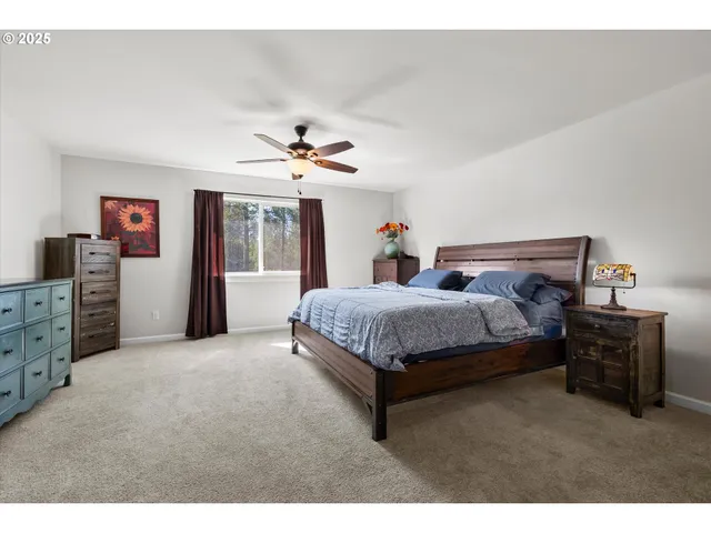 a bed room with a bed and a ceiling fan