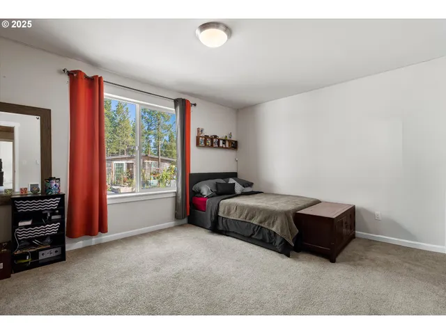 a spacious bedroom with a bed and a area