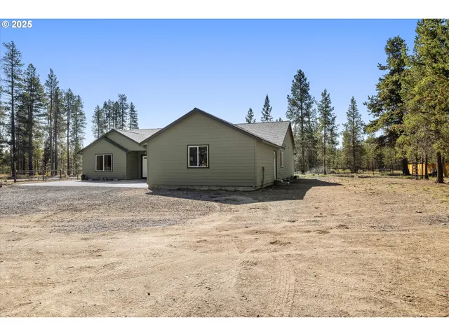 a view of a backyard with patio area