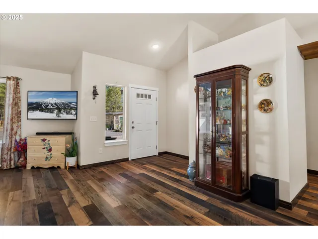 a living room with furniture dining table and wooden floor