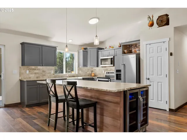 a kitchen with granite countertop a stove and a sink