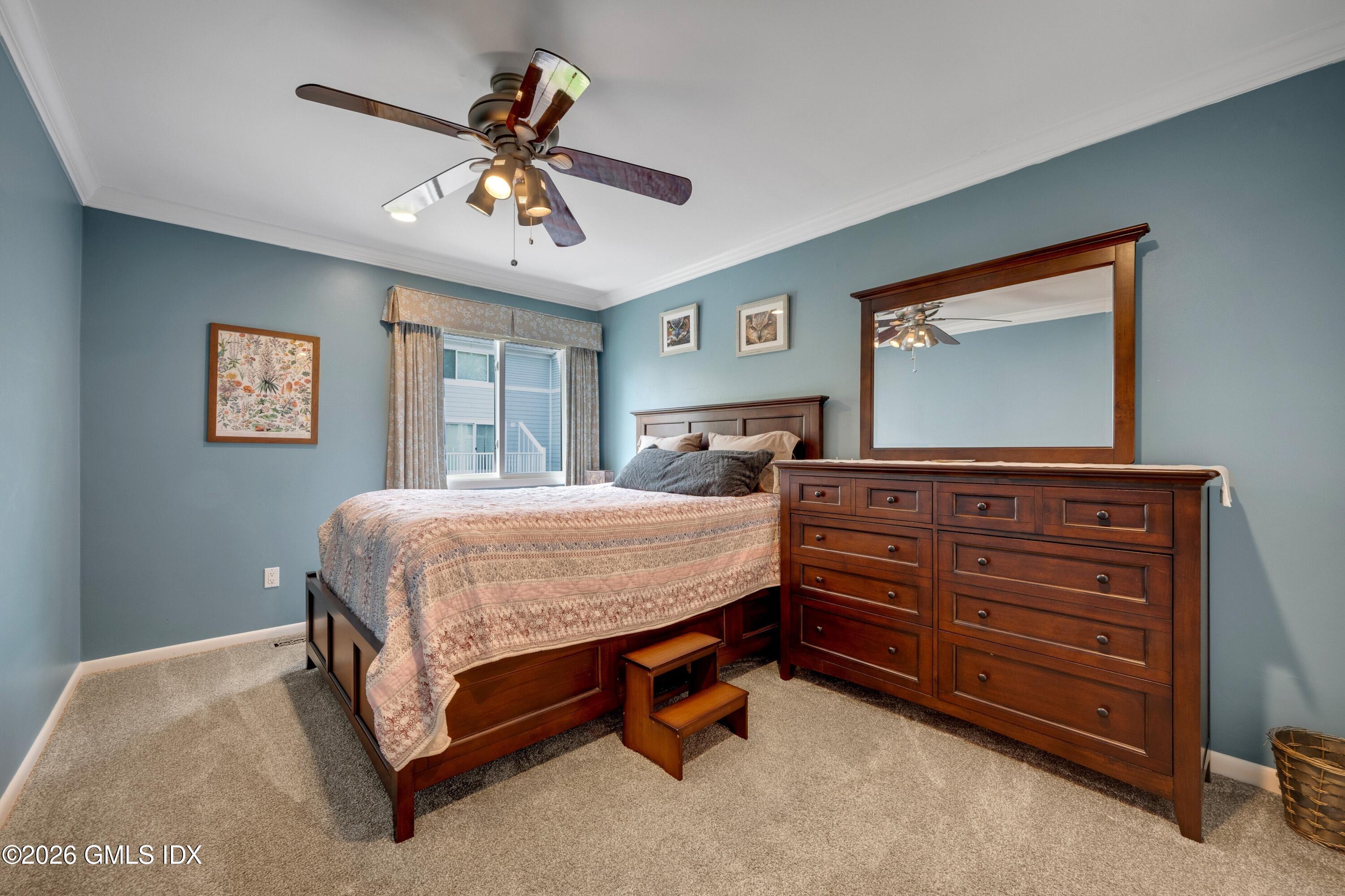 58 Stirrup Lane, Unit 58 Riverside, CT 06878 - Photo 12 of 23 a bedroom with a bed and ceiling fan