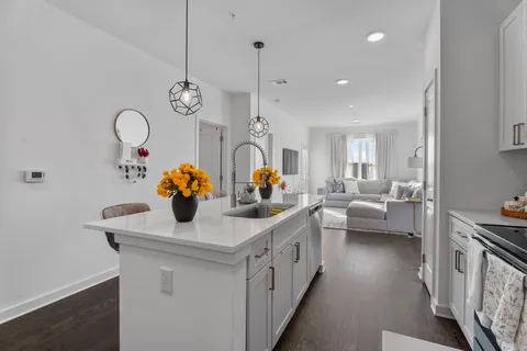 a kitchen with sink a stove and cabinets