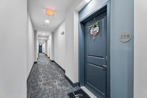 a hallway with sliding door and closet