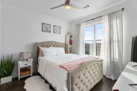 a bedroom with a bed and a window