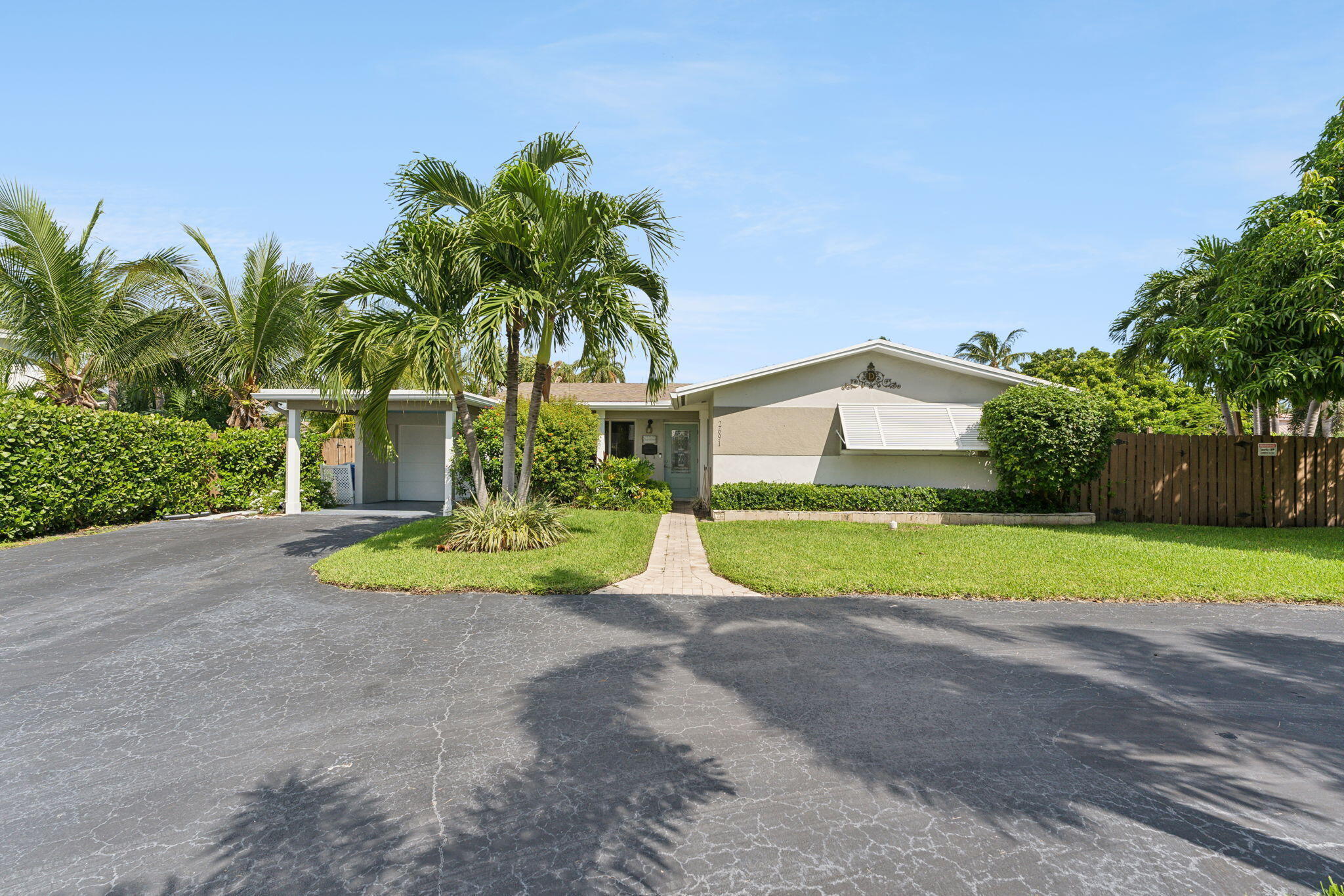 2691 Northeast 18th Street Pompano Beach, FL 33062 - Photo 1 of 34 a front view of a house with yard and green space