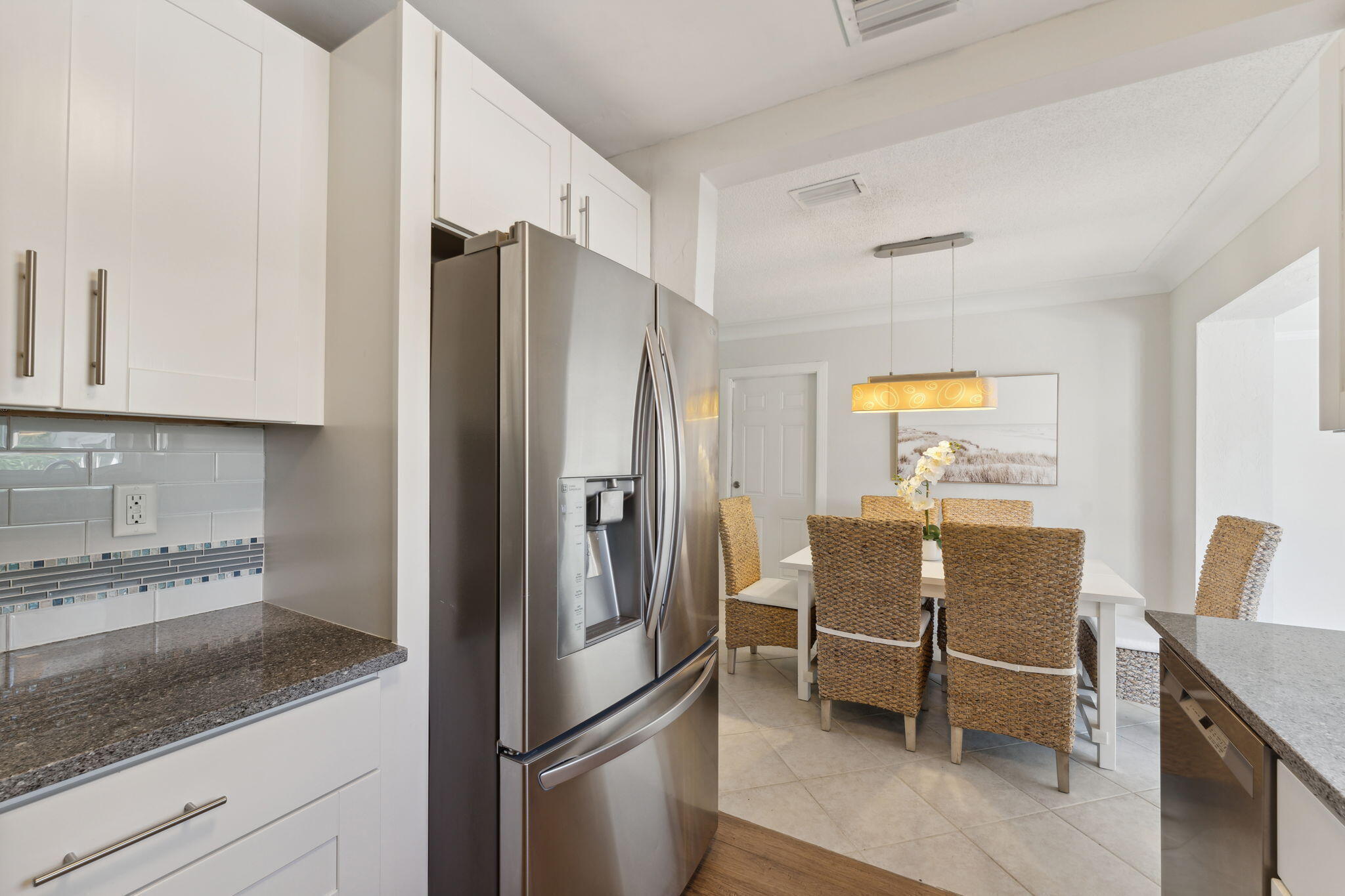2691 Northeast 18th Street Pompano Beach, FL 33062 - Photo 11 of 34 a kitchen with stainless steel appliances granite countertop a refrigerator and a stove top oven