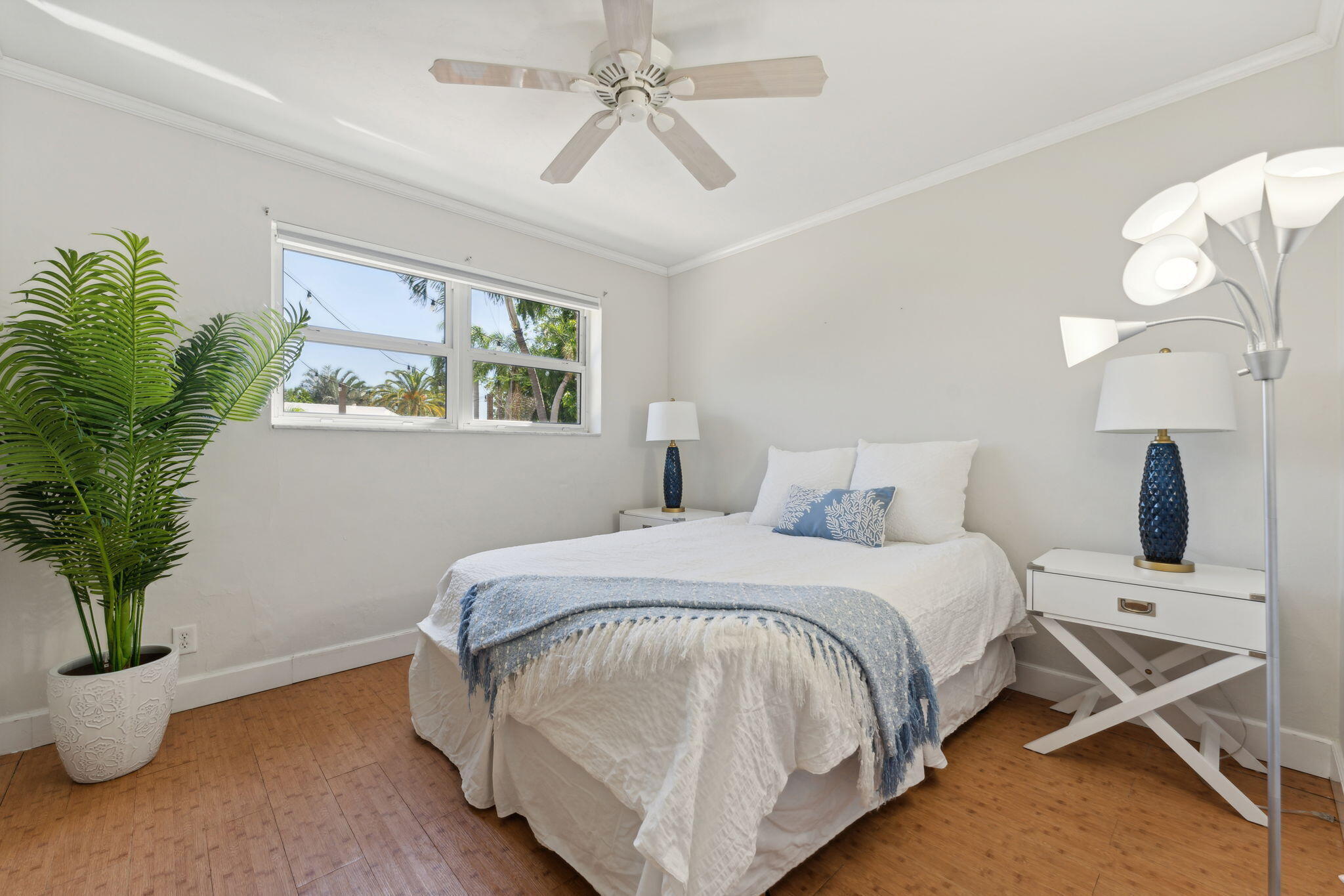 2691 Northeast 18th Street Pompano Beach, FL 33062 - Photo 13 of 34 a bed room with a bed and a potted plant