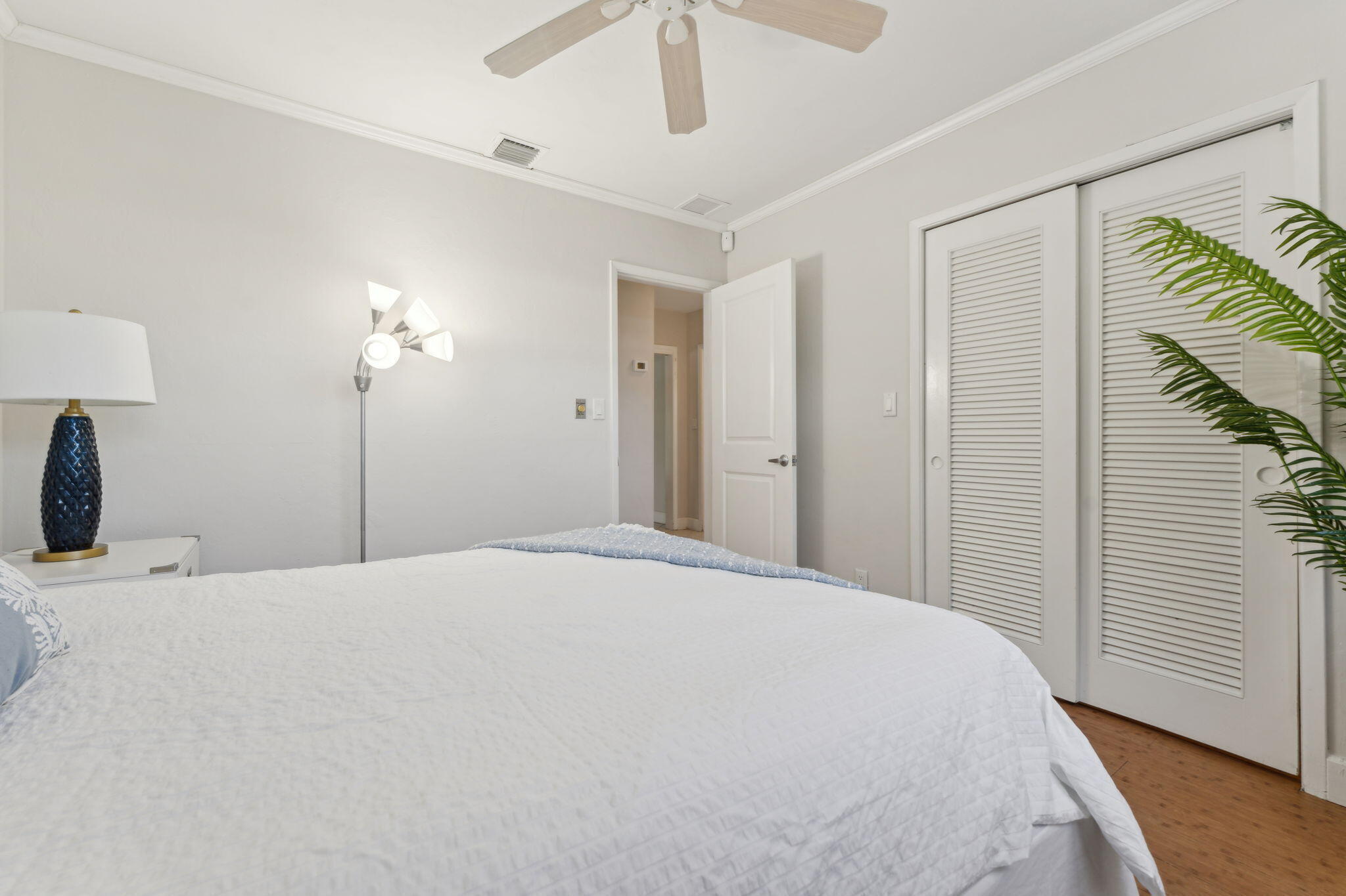 2691 Northeast 18th Street Pompano Beach, FL 33062 - Photo 14 of 34 a large white bed in a bedroom next to a window