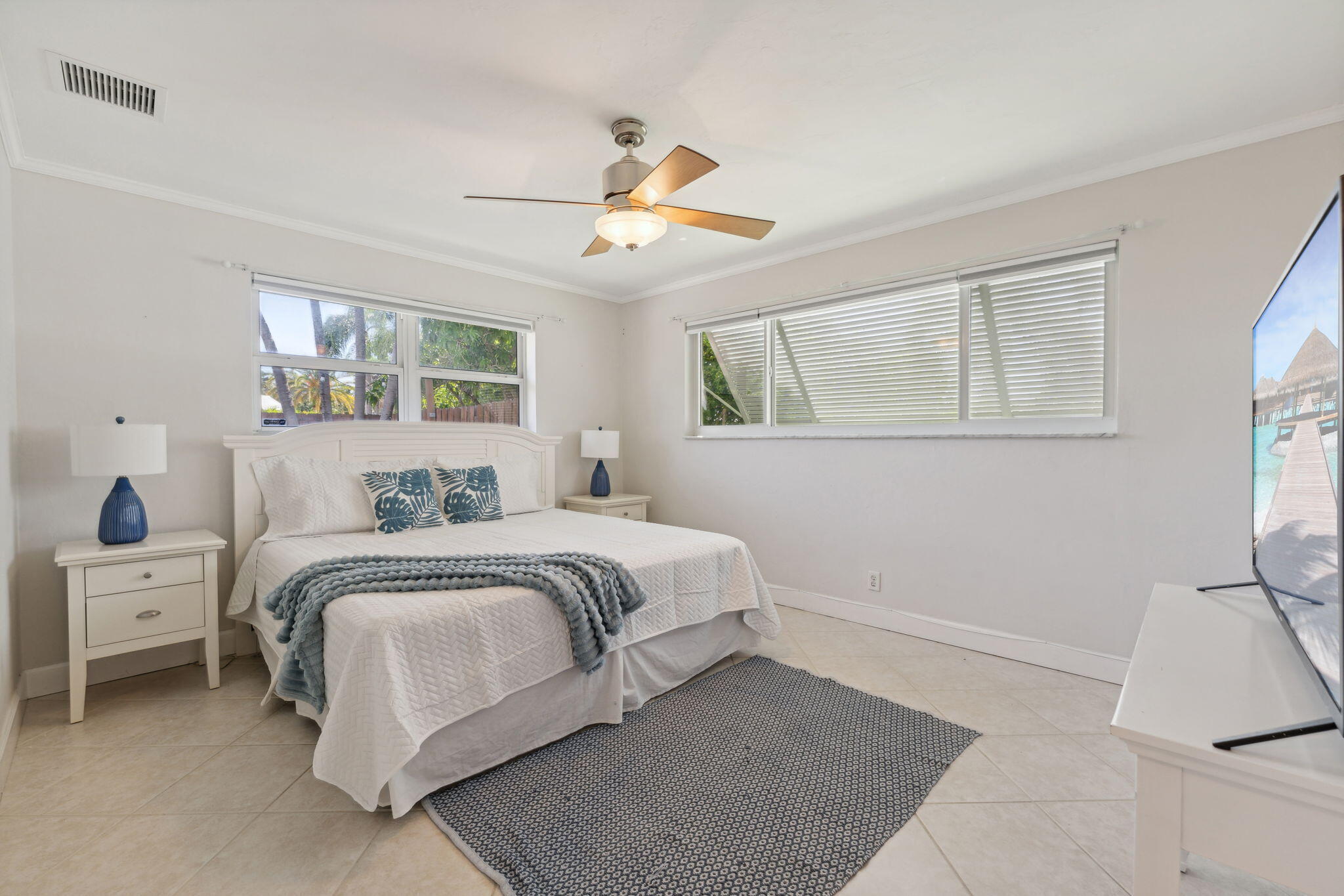 2691 Northeast 18th Street Pompano Beach, FL 33062 - Photo 21 of 34 a bedroom with a bed and a chandelier