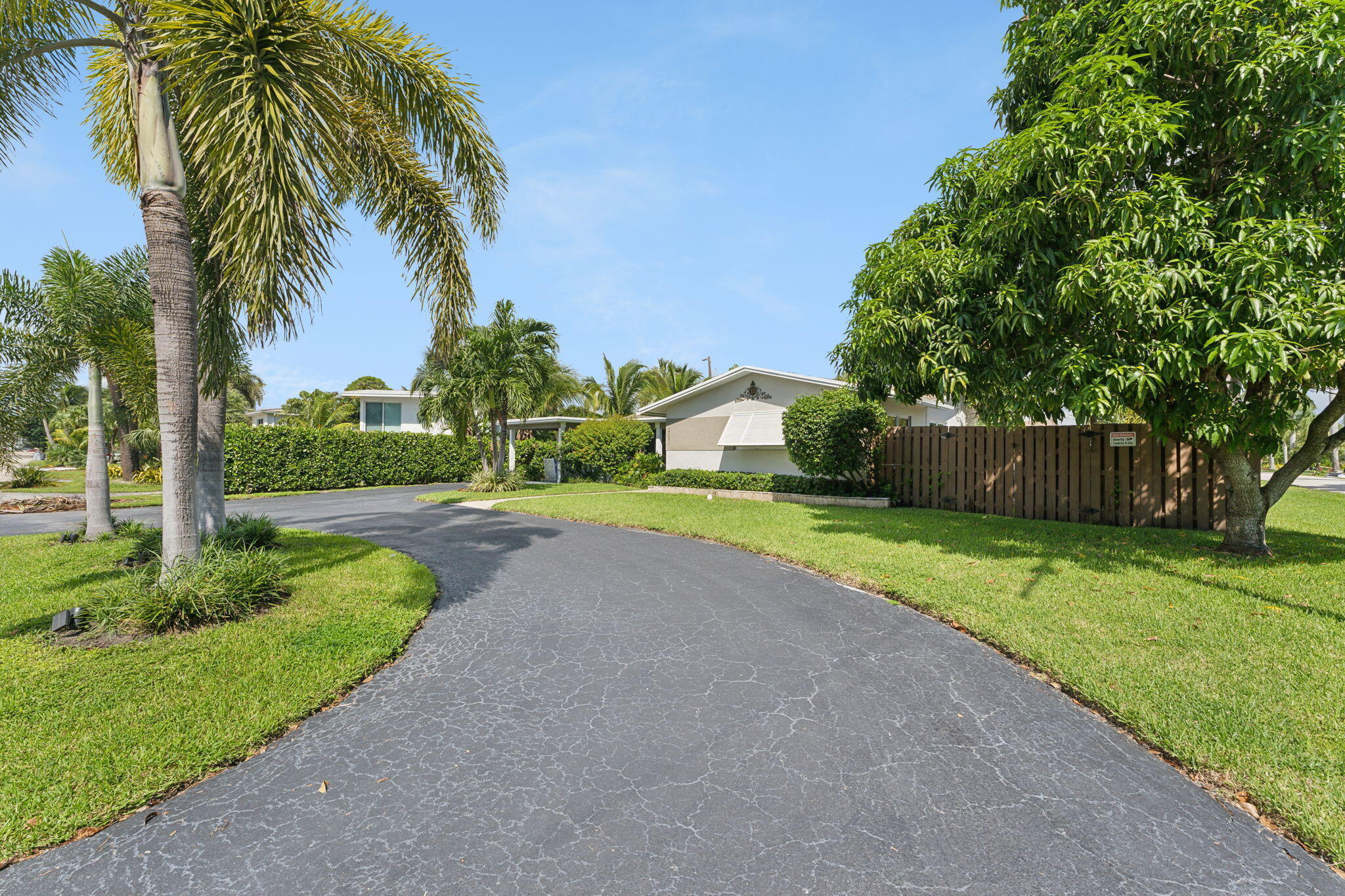 2691 Northeast 18th Street Pompano Beach, FL 33062 - Photo 34 of 34 a view of a house with a big yard and palm trees