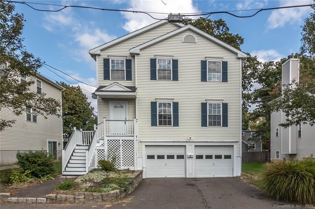 54 Cardinal Street Fairfield, CT 06825 - Photo 1 of 1 a front view of a house with a garden