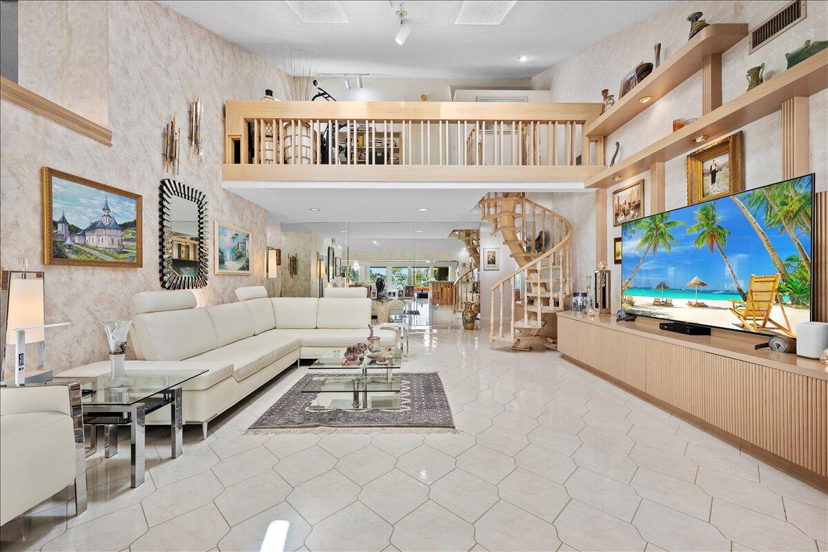 352 River Edge Road Jupiter, FL 33477 - Photo 7 of 56 a living room with furniture and a large window