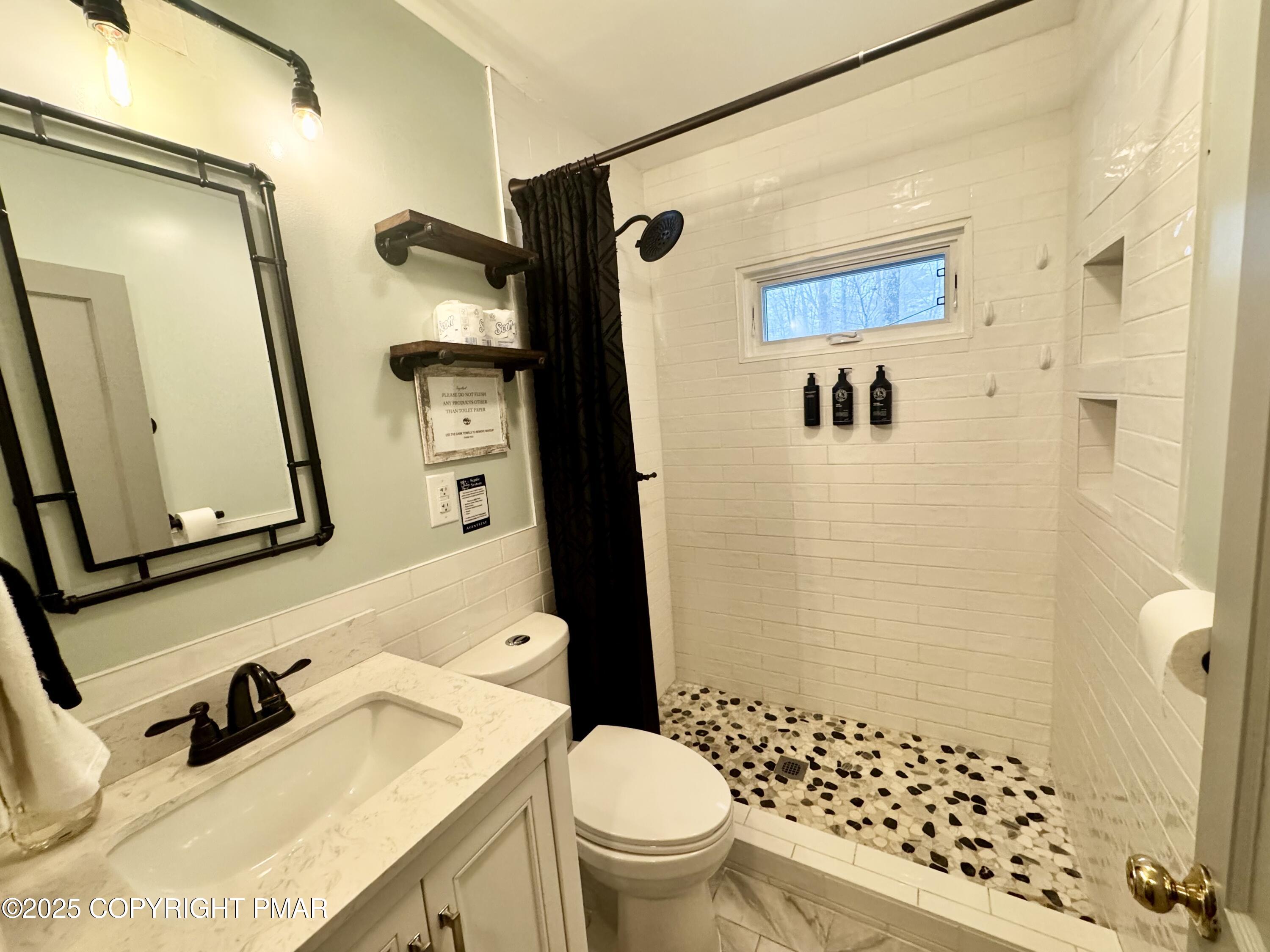 24 Split Rock Road Lake Harmony, PA 18624 - Photo 11 of 42 a bathroom with a sink toilet and shower