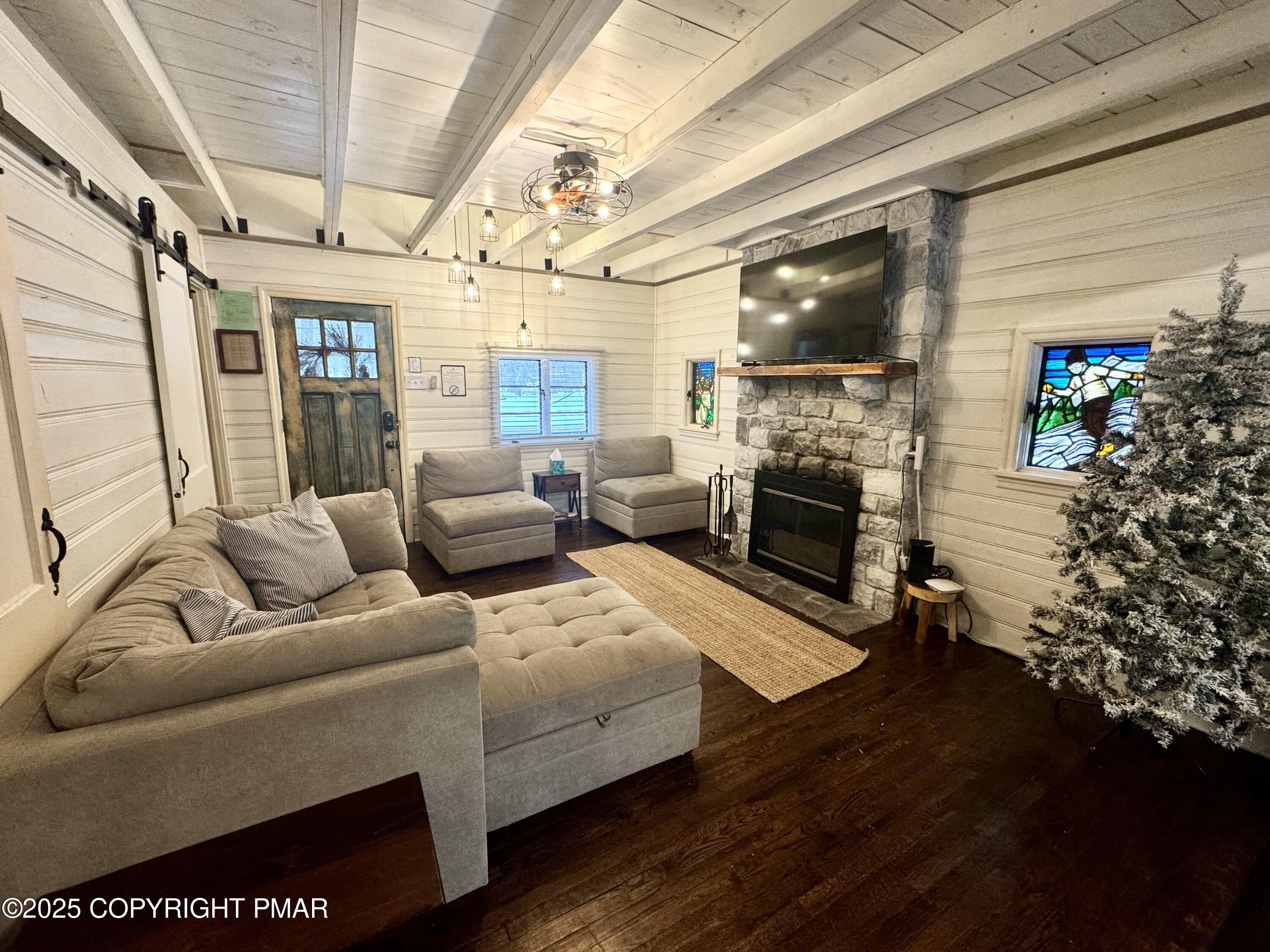 24 Split Rock Road Lake Harmony, PA 18624 - Photo 6 of 42 a living room with furniture wooden floor and a fireplace