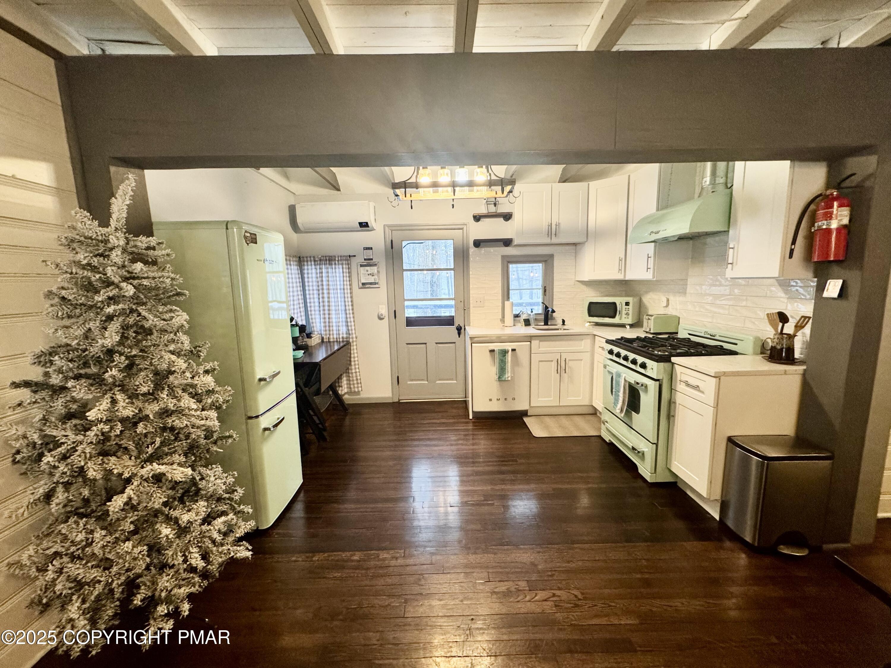 24 Split Rock Road Lake Harmony, PA 18624 - Photo 7 of 42 a kitchen with stainless steel appliances a stove a sink and white cabinets
