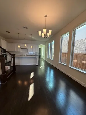 a view of a room with wooden floor