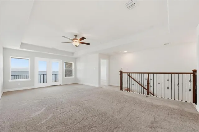 a view of a livingroom with a ceiling fan and window