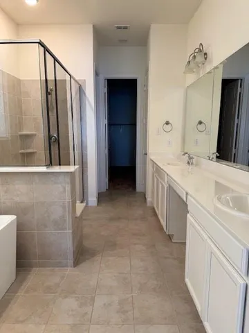 a bathroom with a double vanity sink a toilet and a mirror