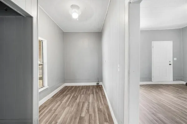 a view of a room with wooden floor