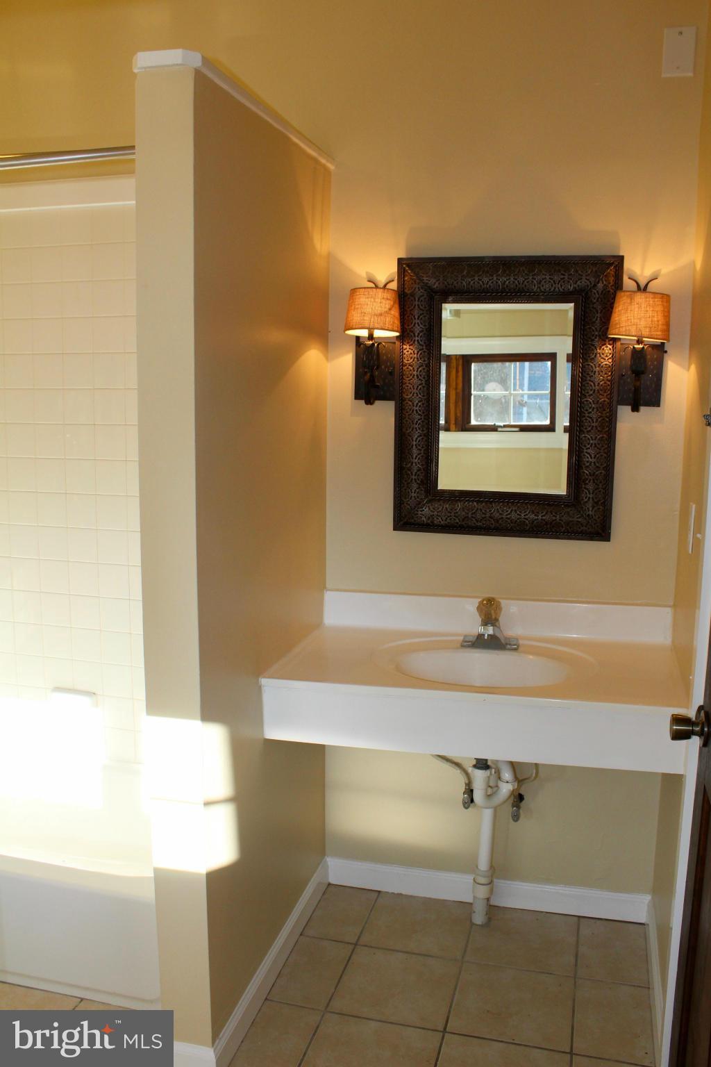 3650 Golf Course Road Martinsburg, WV 25405 - Photo 11 of 16 a bathroom with a sink and a mirror