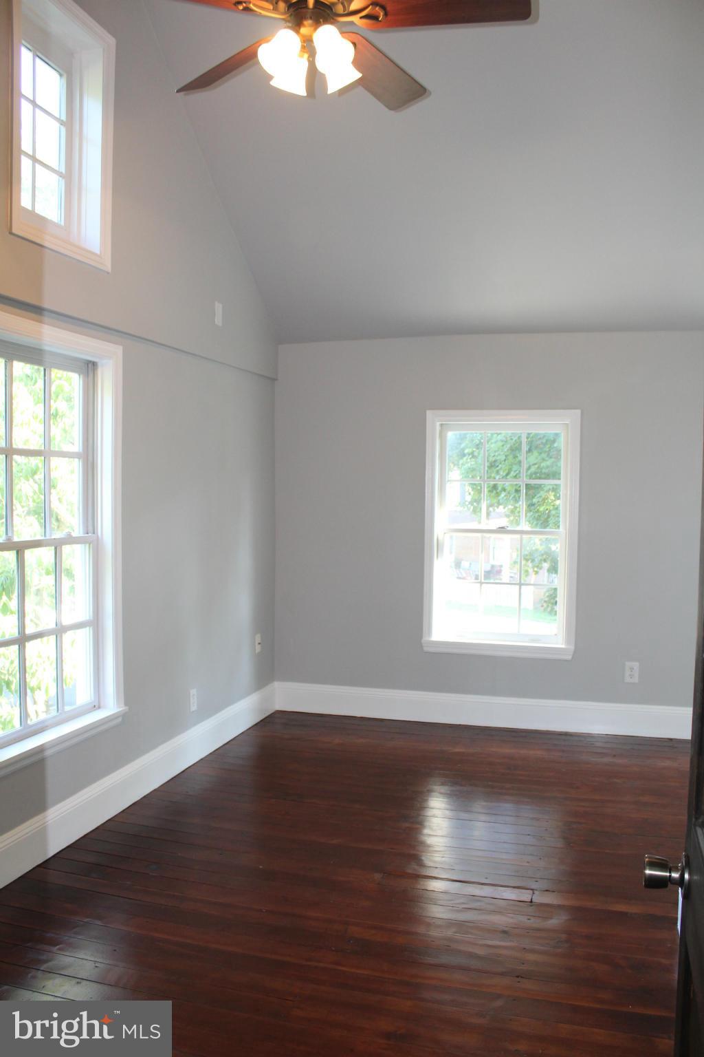3650 Golf Course Road Martinsburg, WV 25405 - Photo 13 of 16 an empty room with wooden floor and windows