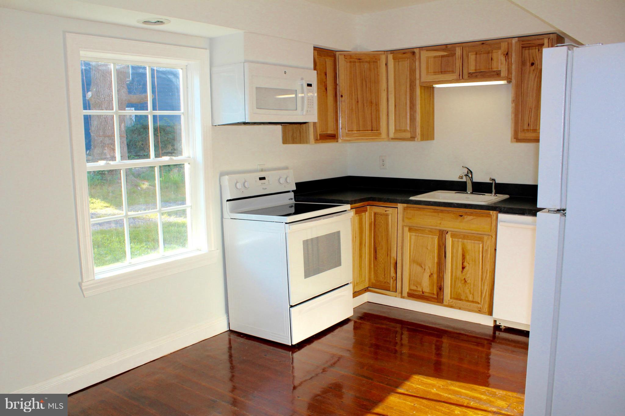 3650 Golf Course Road Martinsburg, WV 25405 - Photo 5 of 16 a view of a kitchen with wooden floor and electronic appliances