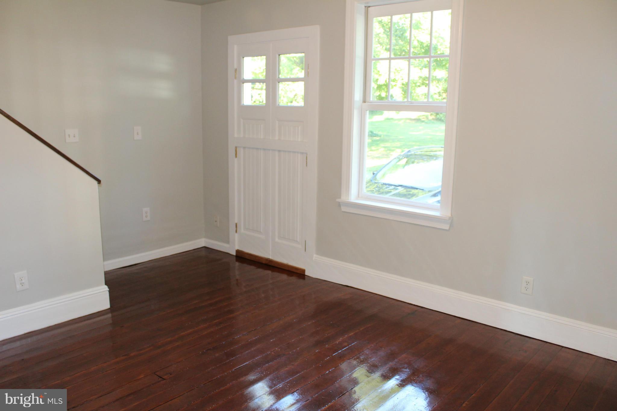 3650 Golf Course Road Martinsburg, WV 25405 - Photo 7 of 16 an empty room with wooden floor and windows