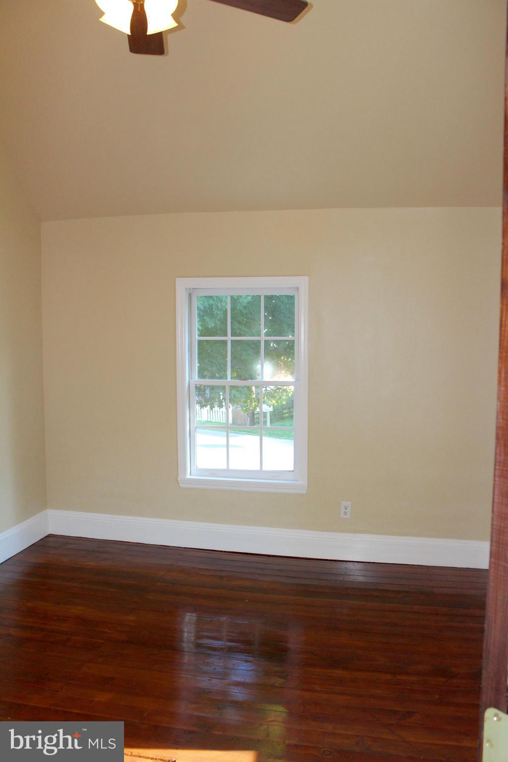 3650 Golf Course Road Martinsburg, WV 25405 - Photo 9 of 16 a view of an empty room with wooden floor and a window