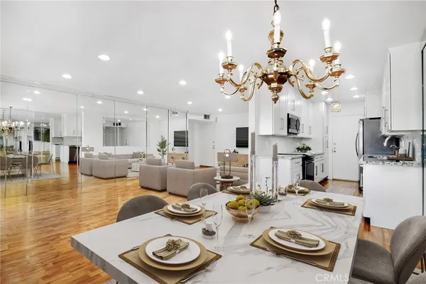 a view of a dining room and hall with furniture