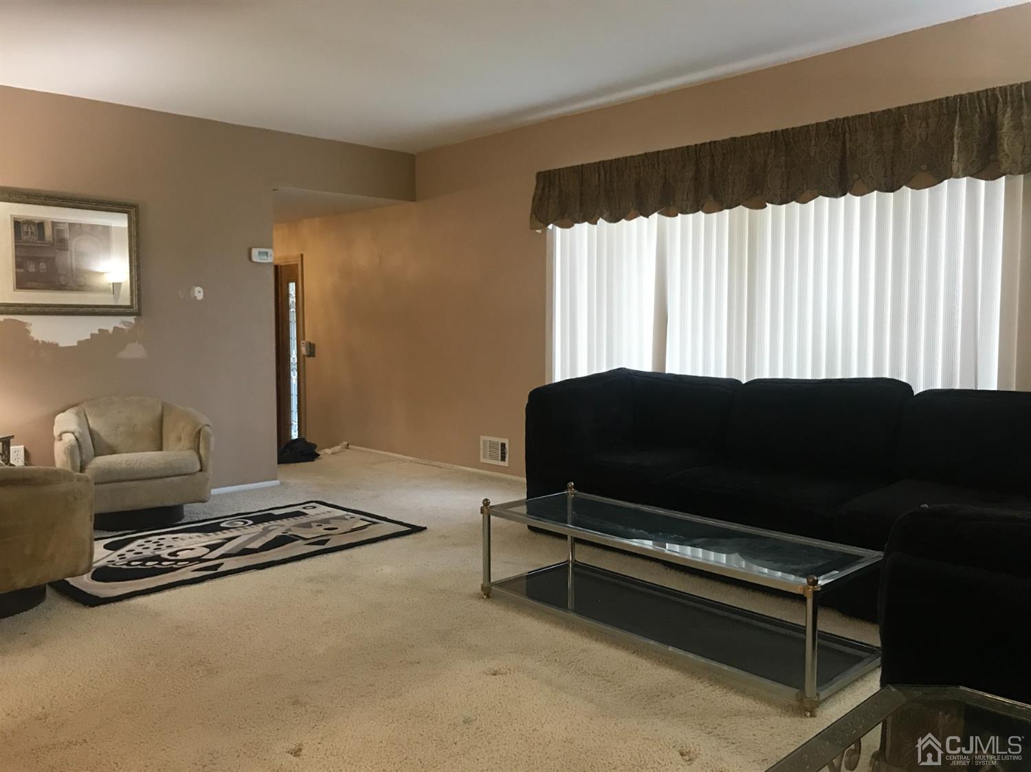 25 Roxy Avenue Edison, NJ 08820 - Photo 5 of 32 a living room with a bed furniture and a window