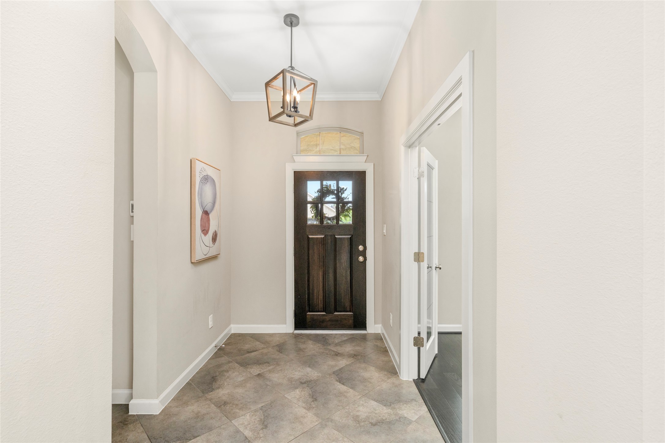 143 Castlegate Lane Houston, TX 77065 - Photo 4 of 33 Updated light fixture with LED bulbs (2020) and solid wood door with window. Note the transom window and access to the mud room on the left-hand side and to the office on right-hand side.