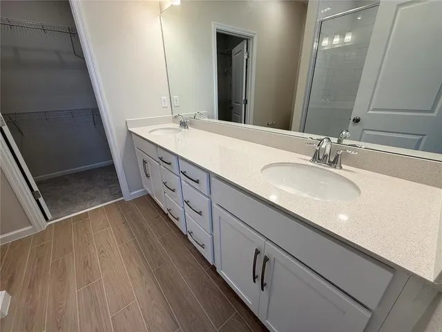 a bathroom with a double vanity sink and a mirror