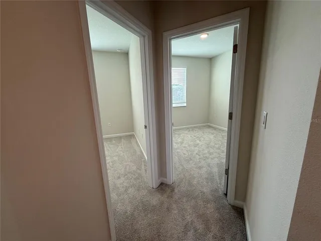 a view of a bathroom from a corridor