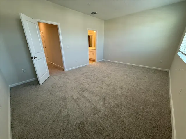 an empty room with windows and closet