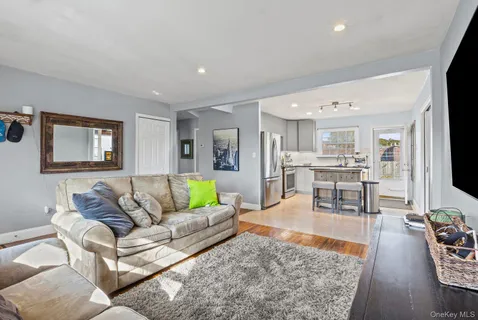 a living room with furniture wooden floor and a flat screen tv