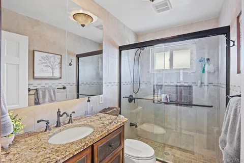 a bedroom with a bed and a flat tv screen on the dresser