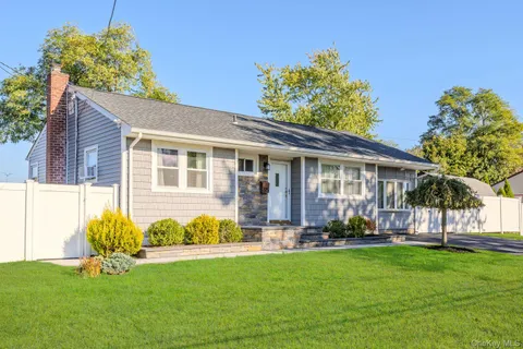 a front view of house with yard and outdoor seating