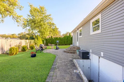 a view of a backyard with sitting area