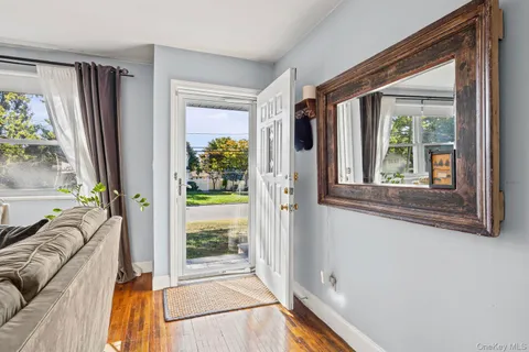 a view of a bedroom with furniture and a window