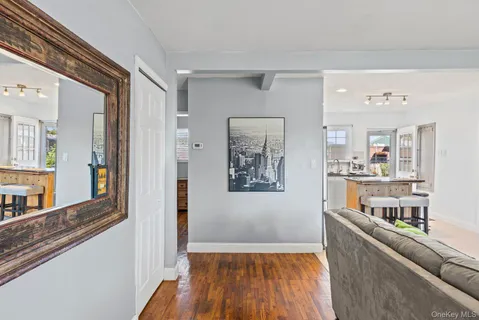 a view of a living room with furniture and wooden floor